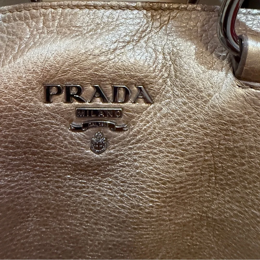 Prada tote bag with detachable crossbody strap in gold leather.